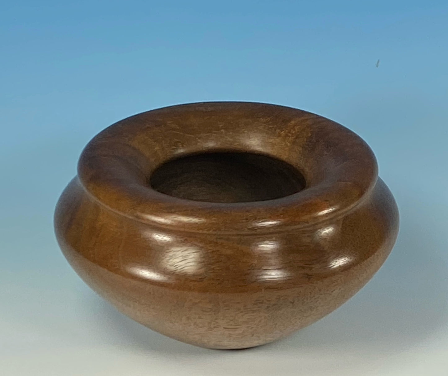 ENCLOSED FORM TURNED FROM FIGURED CLARO WALNUT